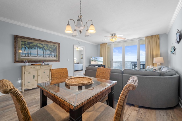 dining room with a textured ceiling, ceiling fan with notable chandelier, light hardwood / wood-style flooring, and ornamental molding