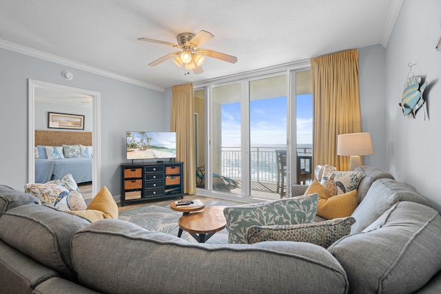 living room featuring expansive windows, ceiling fan, ornamental molding, and hardwood / wood-style flooring