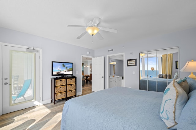 bedroom featuring connected bathroom, access to outside, light hardwood / wood-style flooring, and ceiling fan