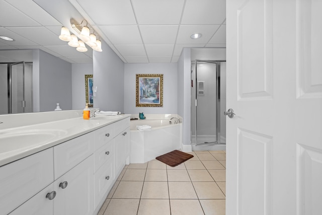 bathroom featuring tile patterned floors, a paneled ceiling, vanity, and plus walk in shower