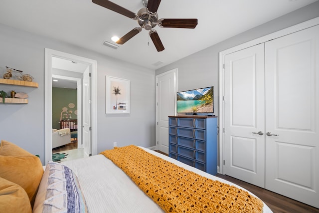 bedroom with ceiling fan, a closet, and dark hardwood / wood-style floors