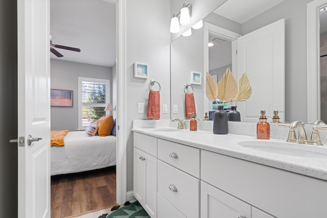 bathroom with hardwood / wood-style flooring, vanity, and ceiling fan