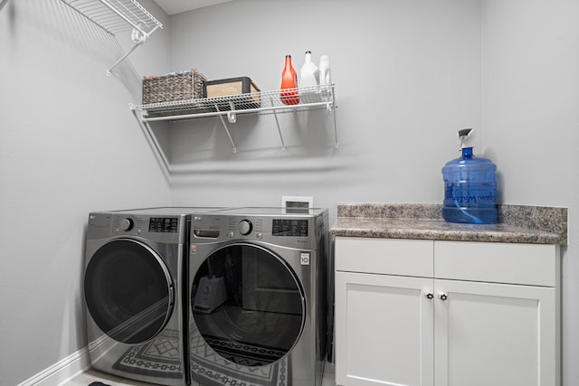 laundry room with cabinets and washing machine and dryer