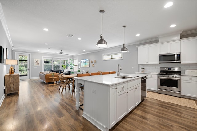 kitchen featuring stainless steel appliances, white cabinets, and sink