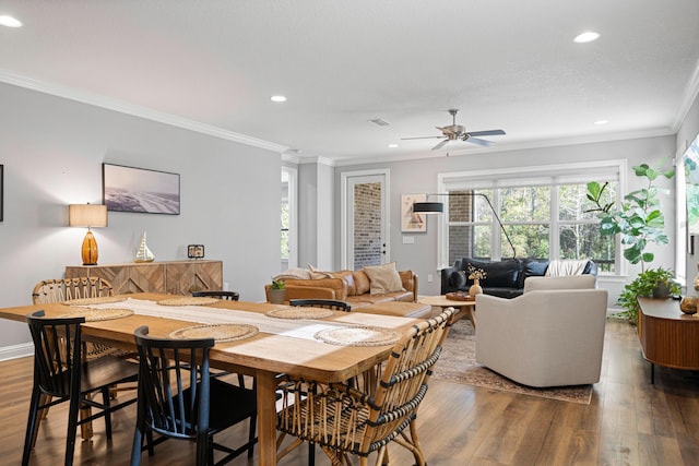 dining room with ceiling fan, wood-type flooring, and crown molding