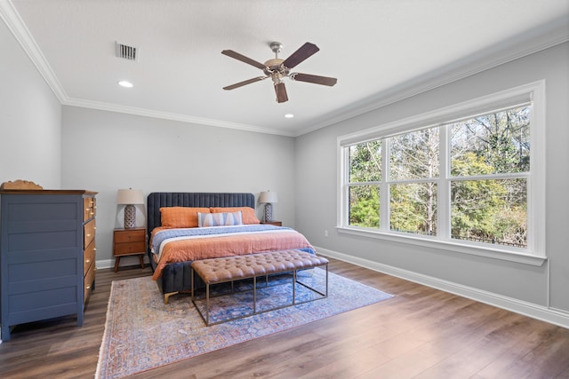 bedroom with ceiling fan, dark hardwood / wood-style floors, and crown molding