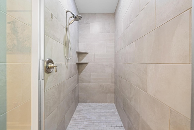 bathroom with a tile shower