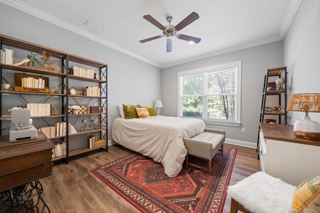 bedroom featuring ceiling fan, dark wood-type flooring, and crown molding