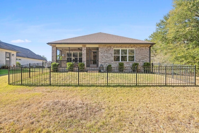 rear view of property featuring a yard