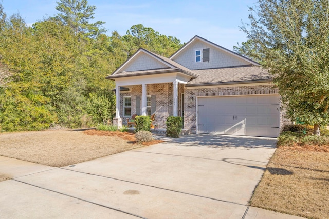 view of front facade featuring covered porch and a garage