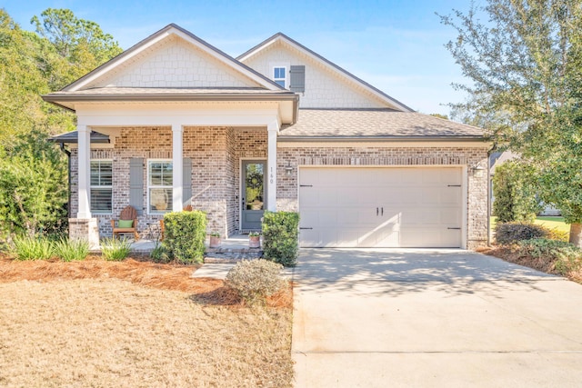 view of front of property with covered porch and a garage