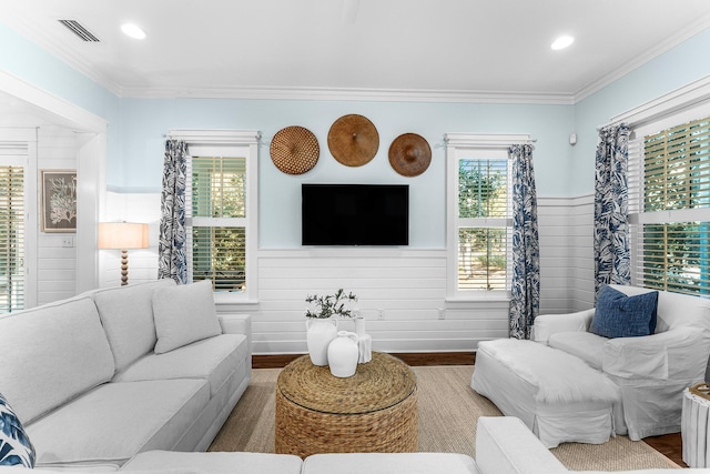 living room with crown molding and wood-type flooring