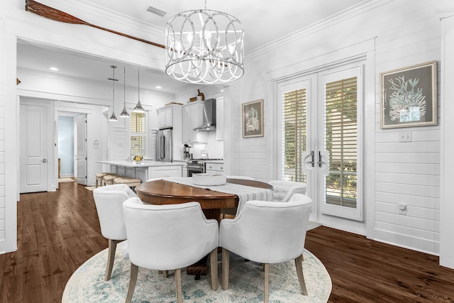 dining space with dark hardwood / wood-style flooring, a healthy amount of sunlight, and crown molding