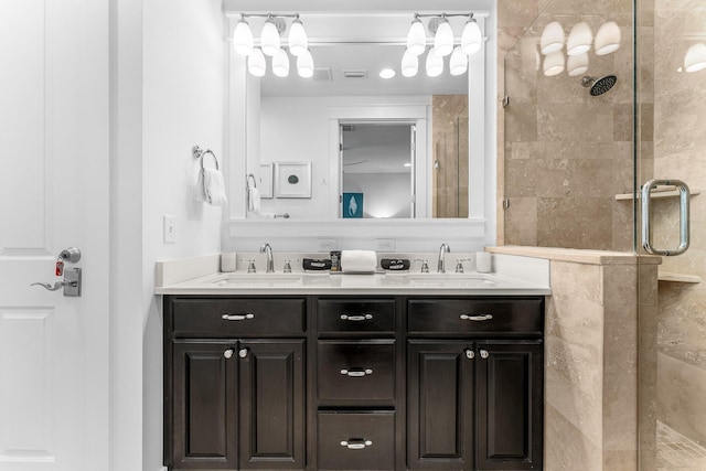 bathroom with vanity and a shower with shower door