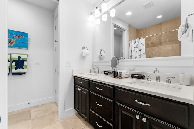 bathroom featuring walk in shower and vanity