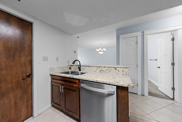 kitchen with sink, light tile patterned floors, dishwasher, and kitchen peninsula