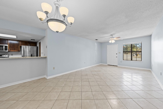 tiled empty room featuring ceiling fan with notable chandelier and a textured ceiling