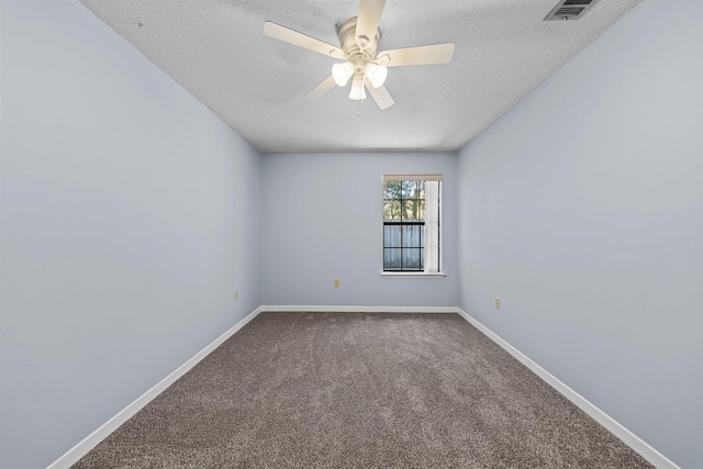 carpeted spare room featuring a textured ceiling and ceiling fan