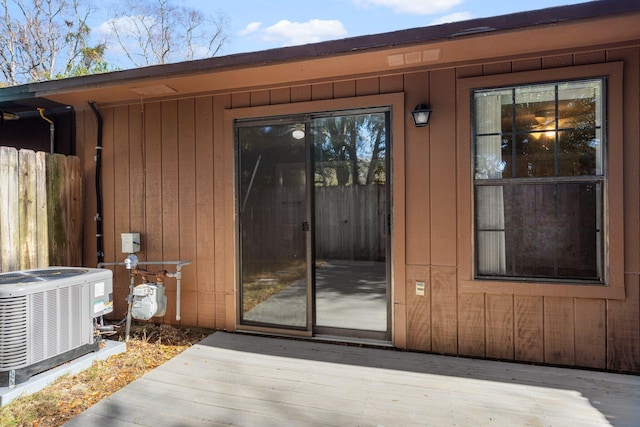 entrance to property with central AC and a wooden deck