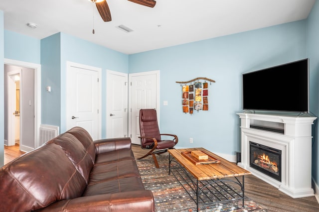 living room with hardwood / wood-style flooring and ceiling fan