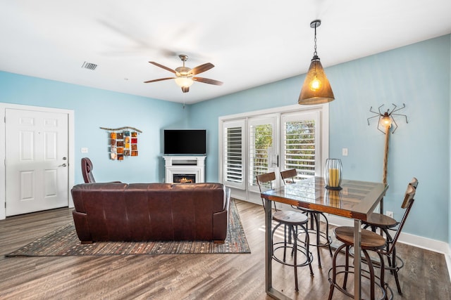 living room with dark hardwood / wood-style floors and ceiling fan