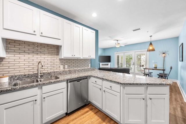 kitchen featuring white cabinetry, sink, and stainless steel dishwasher