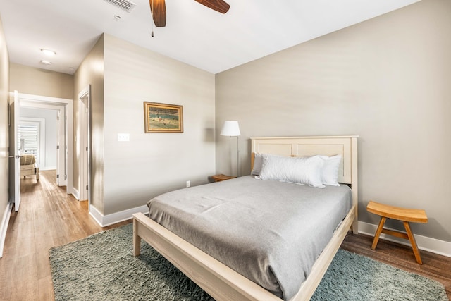 bedroom with hardwood / wood-style flooring and ceiling fan