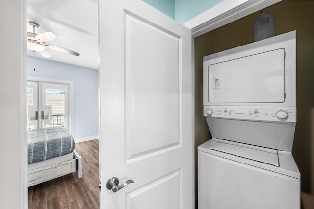 washroom with ceiling fan, stacked washing maching and dryer, and dark hardwood / wood-style flooring