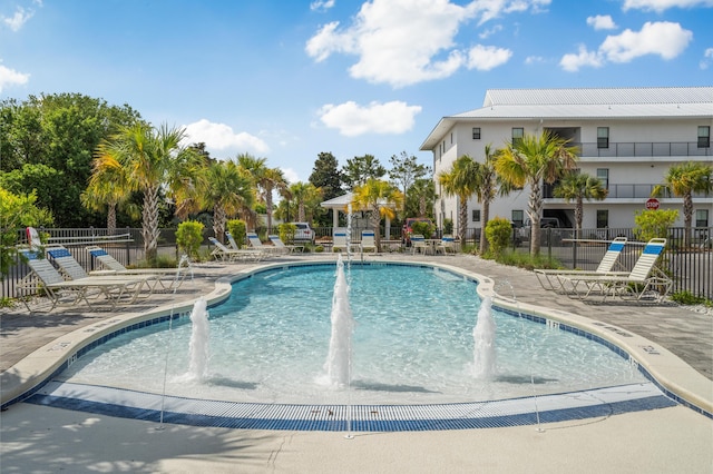 view of swimming pool with a patio and pool water feature