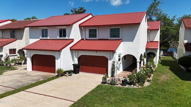 view of front of house with a garage and a front lawn