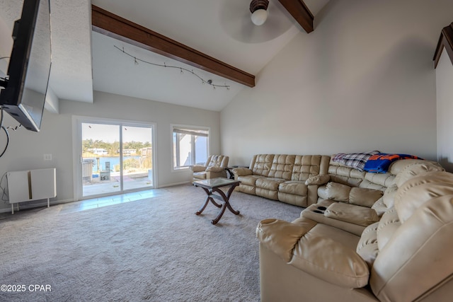 carpeted living room with beam ceiling, ceiling fan, and high vaulted ceiling