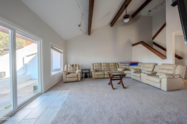 living room featuring vaulted ceiling with beams and light carpet