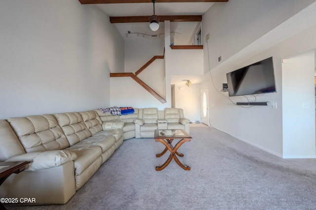 living room with beamed ceiling and carpet flooring