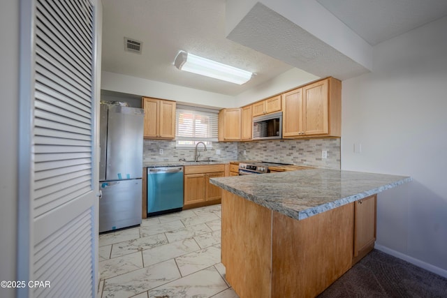 kitchen featuring kitchen peninsula, sink, stainless steel appliances, and light brown cabinets