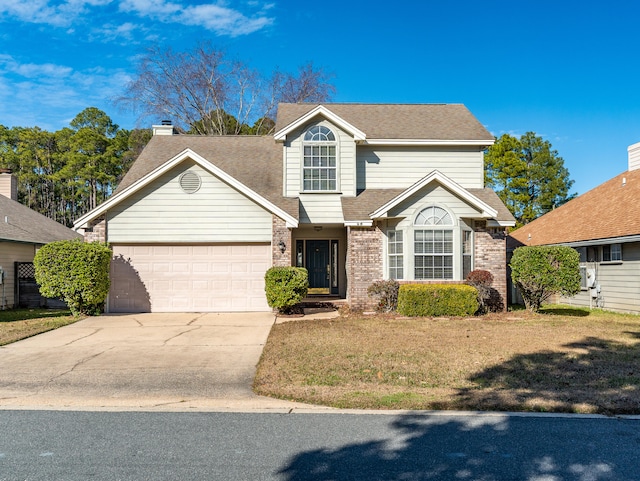 view of property with a garage and a front yard