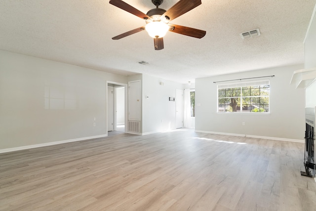 unfurnished living room with a textured ceiling, light hardwood / wood-style flooring, and ceiling fan