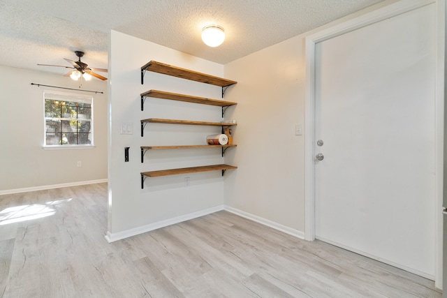 entrance foyer with ceiling fan, light hardwood / wood-style flooring, and a textured ceiling