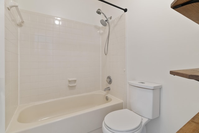 bathroom featuring shower / tub combination and toilet