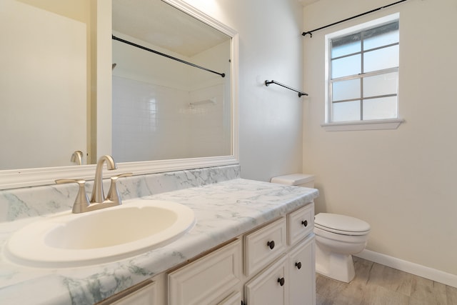 bathroom featuring vanity, toilet, wood-type flooring, and a shower