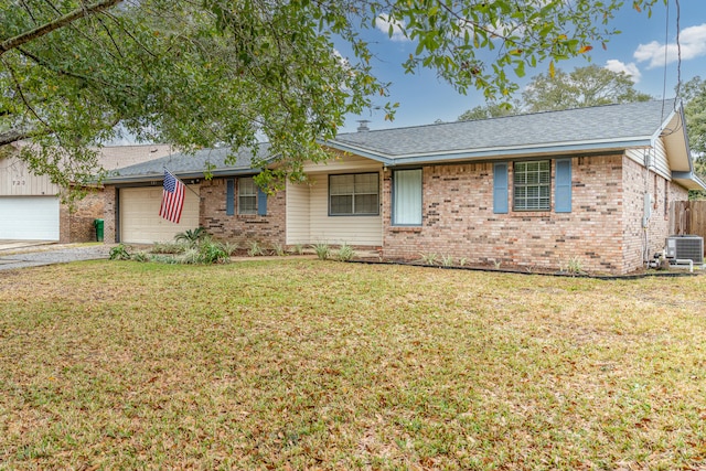 ranch-style house featuring a garage, central AC unit, and a front yard