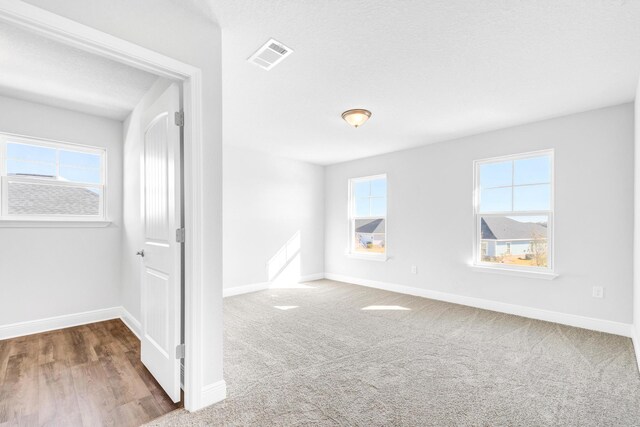 spare room with a textured ceiling