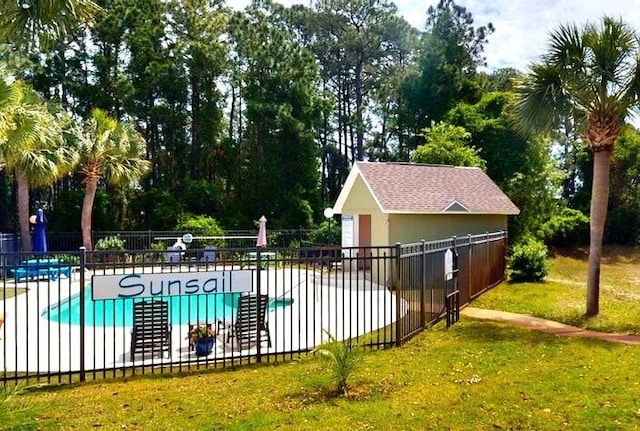 view of pool with a yard