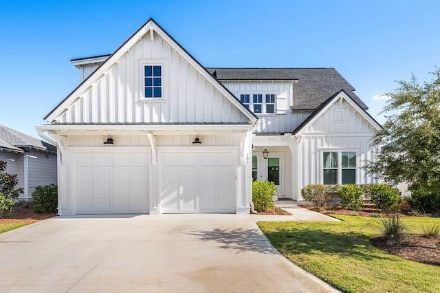 modern inspired farmhouse with a front lawn and a garage