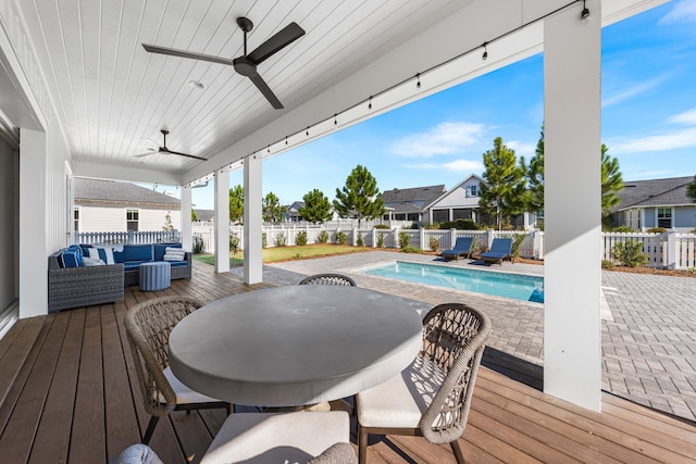 deck with ceiling fan, a fenced in pool, an outdoor hangout area, and a patio