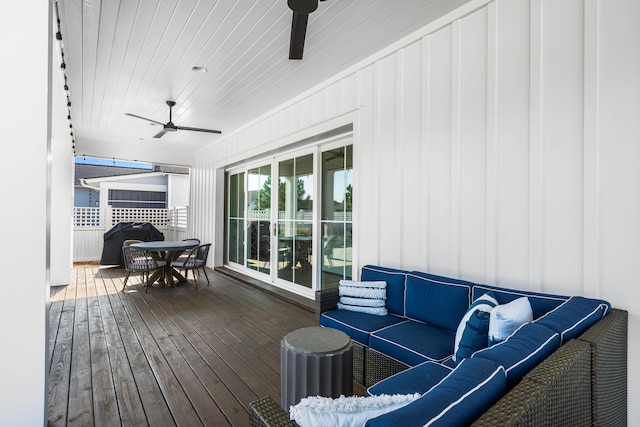 wooden deck featuring grilling area, an outdoor living space, and ceiling fan