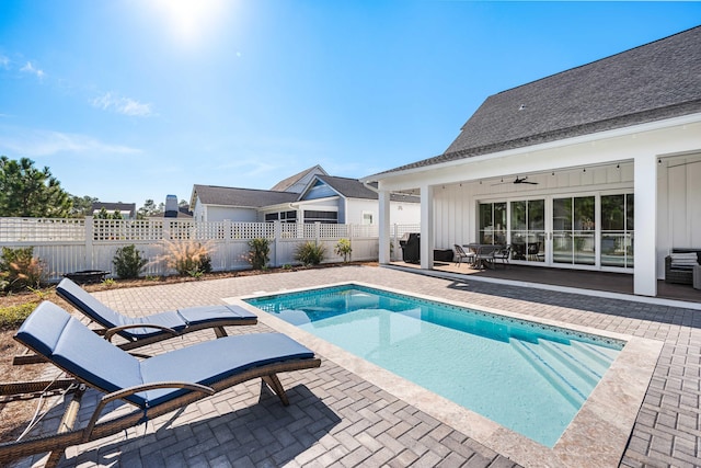 view of pool with a patio area and ceiling fan