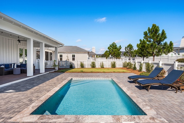 view of swimming pool featuring ceiling fan and a patio area