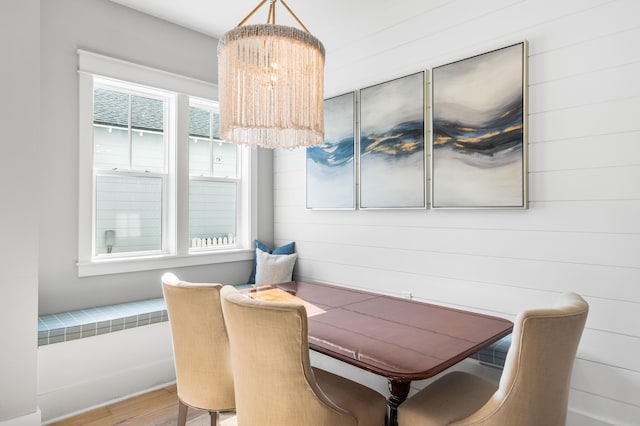 dining room with wood-type flooring and a notable chandelier