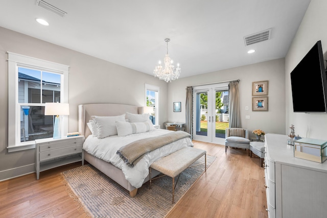 bedroom with access to exterior, french doors, a chandelier, and light hardwood / wood-style flooring