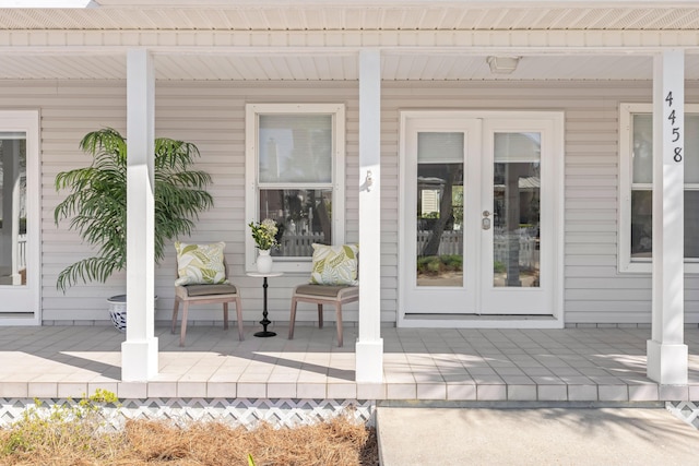 view of exterior entry with french doors and covered porch